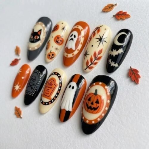 Retro-inspired press-on nails for the spooky season featuring black cats and pumpkins