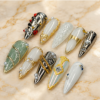 pearlescent chrome press-on nails with gold swirls, silver panels, milky white, sage shimmer and pearl-like beads