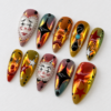 Gothic press-on nails featuring scary face and star patterns.