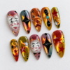 Gothic press-on nails featuring scary face and star patterns.