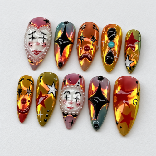 Gothic press-on nails featuring scary face and star patterns.