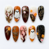 Autumn Halloween ghost press-on nails with amber and cream backgrounds, gold-tone leaves, white ghosts and floral details