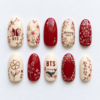 BTS Arirang floral press-on nails in crimson and ivory with blossoms, leafy branches, Korean lettering and a whale