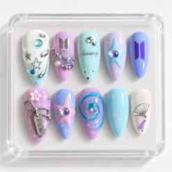 BTS aurora press-on nails in blue, lavender and pink with star accents, silver charms and ARIRANG lettering