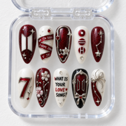 BTS burgundy press-on nails with ivory accents, silver stars, flowers, red gems and member-name bands