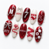 BTS-themed press-on nails in red and black, featuring "ARMY" lettering, bows, the group's logo, and musical notes.