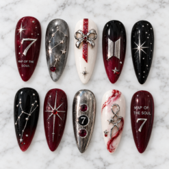 BTS galaxy press-on nails in burgundy, black and silver with star maps, rhinestones and a raised number 7