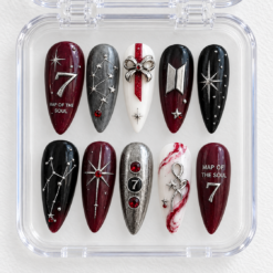 BTS galaxy press-on nails in crimson, black and silver with star art, glitter and a raised number 7 in a case