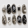 BTS portrait press-on nails in black, ivory and silver with star details, pearl accents and chrome-style swirls