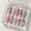 BTS press-on nails featuring members' names and the number 7.