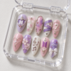 BTS press-on nails featuring members' names and the number 7.