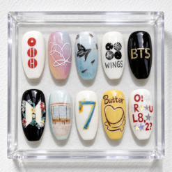 BTS album art press-on nails with WINGS and Butter lettering, number 7, floral artwork and colorful accents