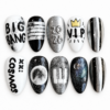 Ten glossy black, white and silver press-on nails with metallic stripes, stars, a crown, space-inspired designs and fan-style lettering.