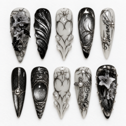 Black silver gothic press-on nails with smoky gray filigree, raised floral details, metallic textures and gem-like accents.