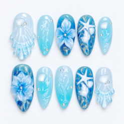 Blue ocean press-on nails with jellyfish, seashells, starfish, sculpted flowers and sparkling aqua details