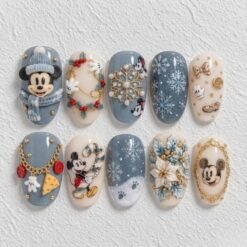 Blue winter press-on nails with snowflakes, festive florals, gold accents and mouse-character designs.