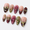 leafy motifs, a dimensional flower, metallic bands press on nails