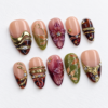 leafy motifs, a dimensional flower, metallic bands press on nails
