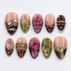 leafy motifs, a dimensional flower, metallic bands press on nails