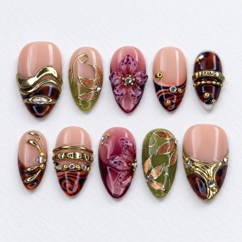 leafy motifs, a dimensional flower, metallic bands press on nails