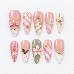 Pink Christmas press-on nails in blush, ivory and sage with bows, a tree, snowflakes, holly, poinsettia and gold-tone accents
