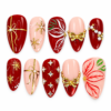 Burgundy bow Christmas press-on nails with gold bows, snowflakes, gems and botanical accents.