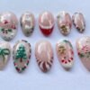 Press-on nails featuring twisted candy cane and Santa hat designs.