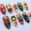 Press-on nails with a raised 3D red bow design.