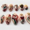 Press-on nails featuring a design of vibrant red berry clusters.