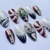 Press-on nails featuring a white-topped, silver-glitter design with sharp, snow-capped tips.