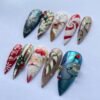 Press-on nails featuring a pine-bough pattern and rhinestone embellishments.