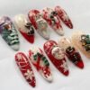 Sheer, glittery press-on nails featuring a snowman wearing a Christmas hat.