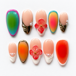 Gradient floral press-on nails in peach, coral and teal with ombré panels, red flowers, gold-tone details and pearl-like accents