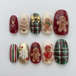 Christmas gingerbread press-on nails in red, cream and green plaid with gingerbread men, a gold bow and a white snowflake