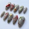 Press-on nails with raised 3D red bow designs