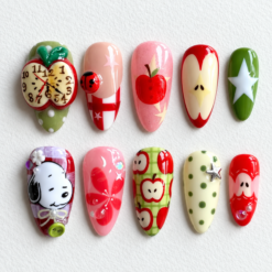 Christmas apple press-on nails with red and green apples, an apple clock, stars and a cartoon dog