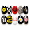 G-Dragon Black statement press-on nails with checkerboard, smiley, peace, daisy and heart designs plus glitter accents