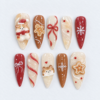 Gingerbread Christmas press-on nails in cream, cinnamon brown and red with teddy bears, cookie art, bows and snowflakes