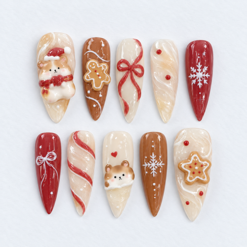 Gingerbread Christmas press-on nails in cream, cinnamon brown and red with teddy bears, cookie art, bows and snowflakes