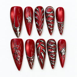 Gothic burgundy press-on nails with deep red shimmer, sculpted silver chrome lines and raised textures