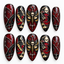 Gothic stained glass press-on nails with a skull moth, crescent moons, bats, red droplets and silver linework.