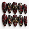 a skull-centered moth, crescent moons, bats, red accents press on nails
