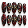 a skull-centered moth, crescent moons, bats, red accents press on nails