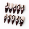 French-inspired tips, sweeping thorn-like lines and pointed black details