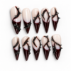 French-inspired tips, sweeping thorn-like lines and pointed black details