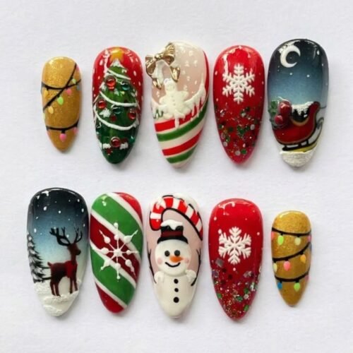 Holiday snowman press-on nails in red, green and gold with a 3D snowman, a sleigh under the moon, a reindeer and lights