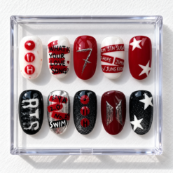 K-pop fan press-on nails in burgundy, red, black and white with stars, glitter, music-themed text and emblem designs