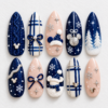 Navy christmas press-on nails with snowflakes, plaid, bows, snowy trees and mouse-head silhouette accents.