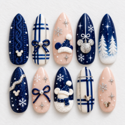 Navy christmas press-on nails with snowflakes, plaid, bows, snowy trees and mouse-head silhouette accents.