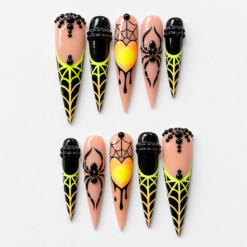 Spider web press-on nails in peach, black and neon yellow with spider motifs, web lines, bead details and a bright heart